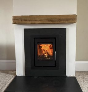 Rustic wooden beams installed above a fireplace in a Cornwall property