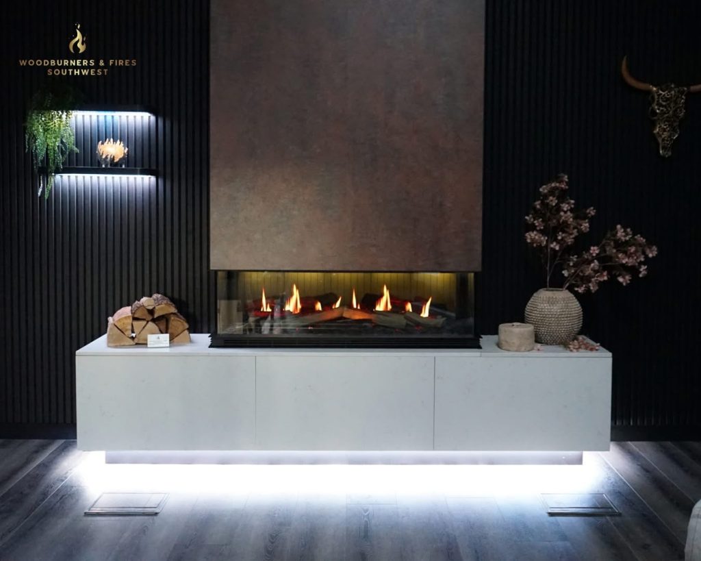 Modern woodburner installed in a stylish living room with a media wall in Cornwall home