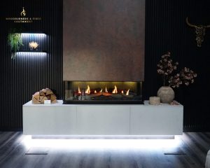 Modern woodburner installed in a stylish living room with a media wall in Cornwall home