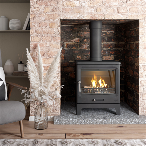 Modern Heta wood-burning stove installed in a Cornwall home with stone hearth surround