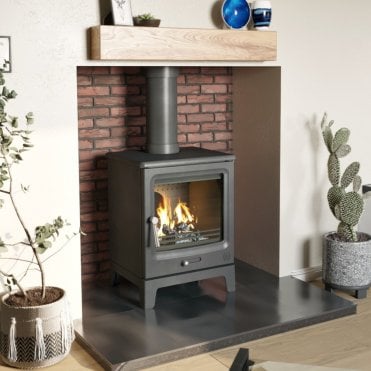 Lotus multi-fuel stove fitted with twin-wall flue system in a cosy Cornwall living room