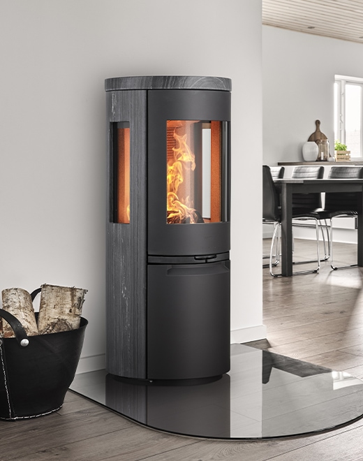 Heta wood-burning stove with side glass panel showcasing flames in Cornwall home