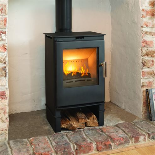 Stone fireplace surround and hearth installed around a multi-fuel stove in a Cornwall living room